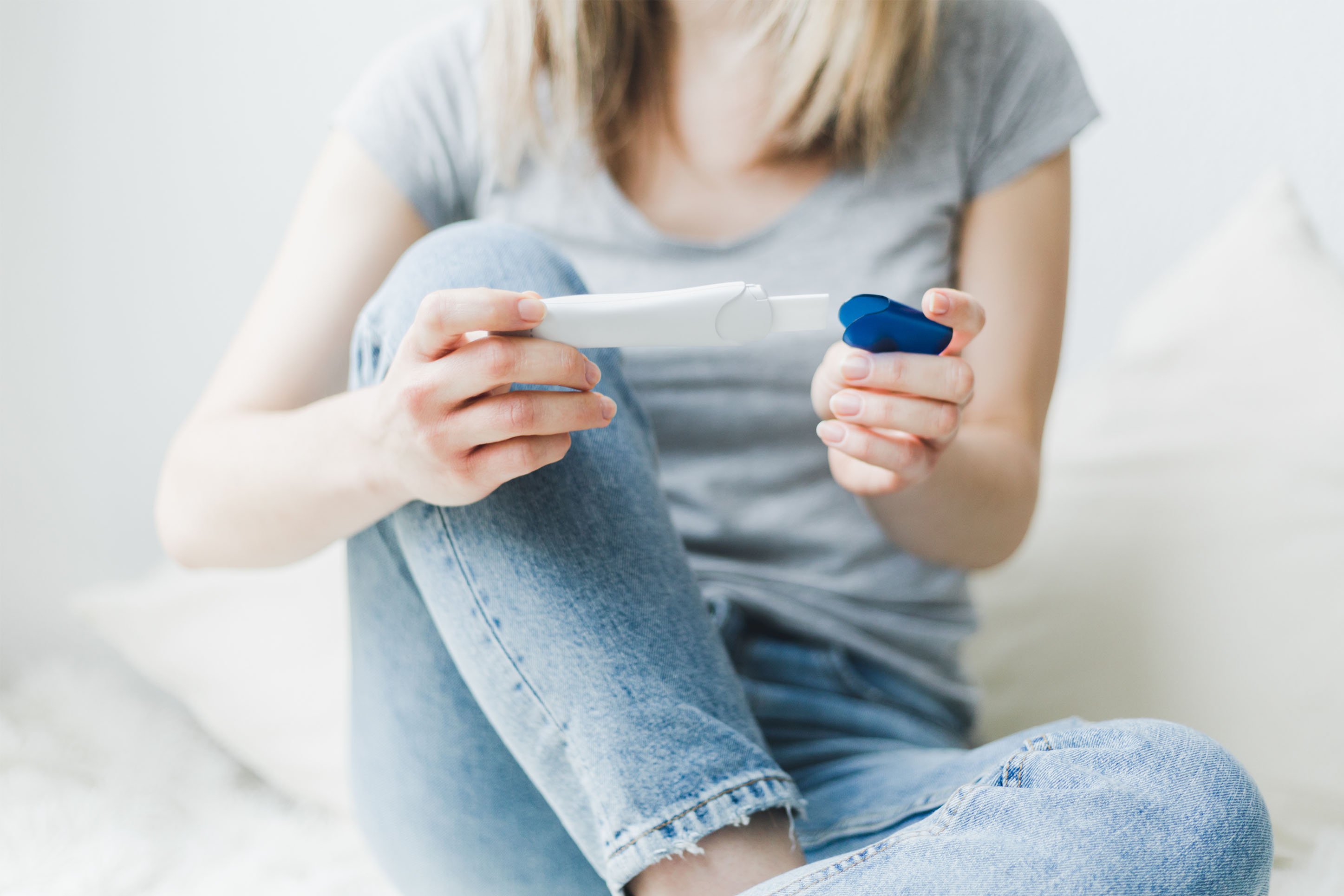 Woman looking at a pregnancy or fertility test.