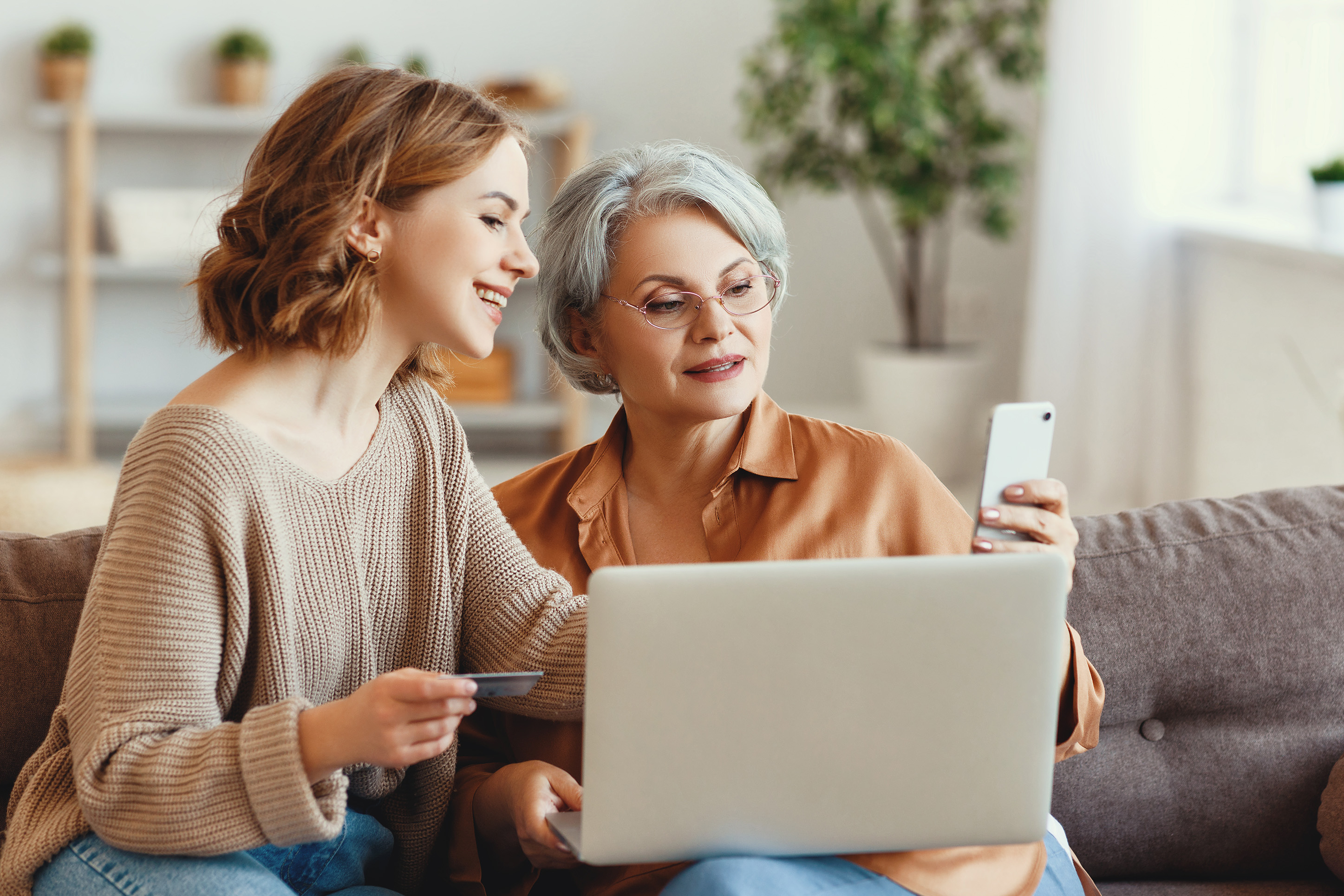 Two women doing online banking from home. 