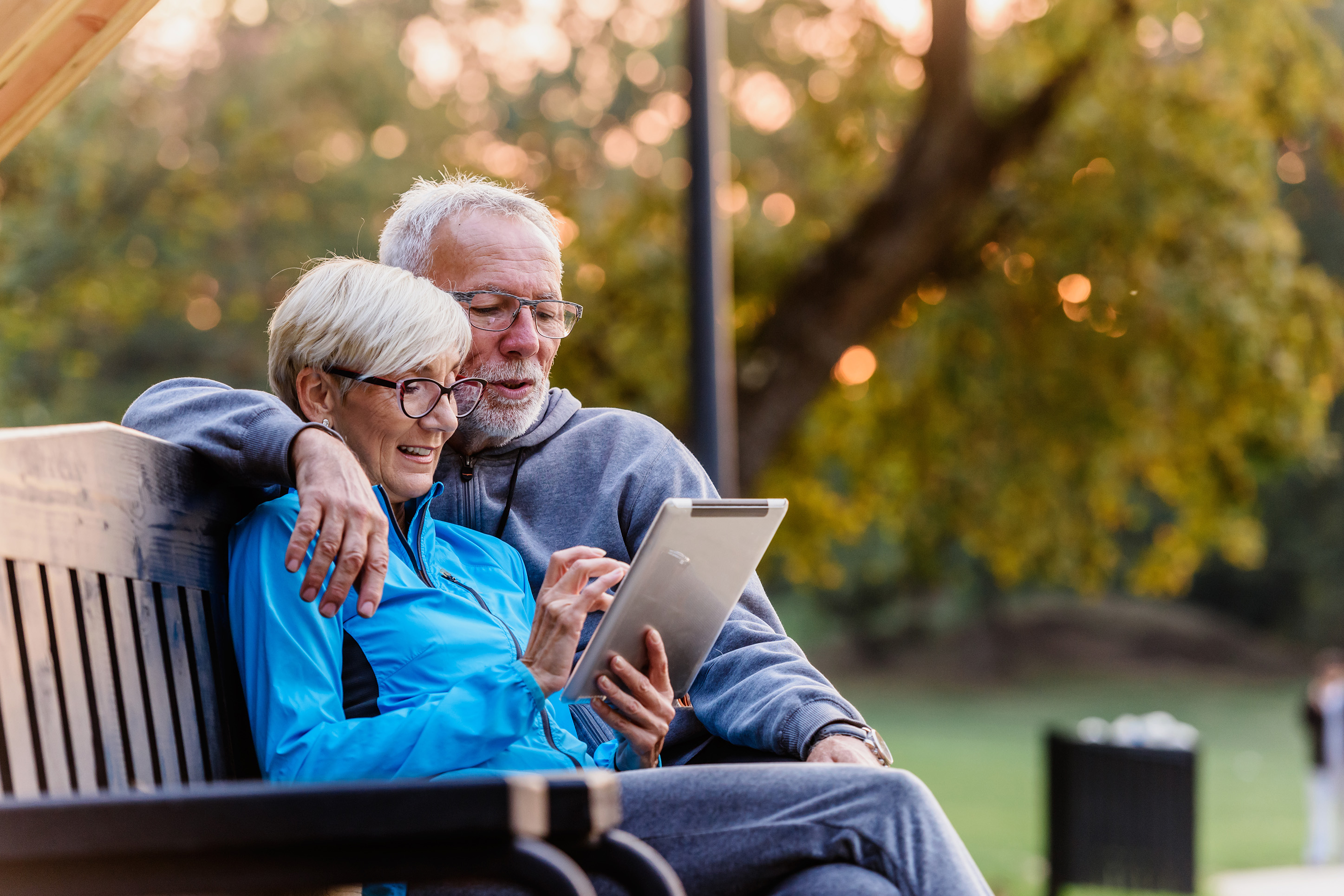Couple looking at their savings on an ipad.