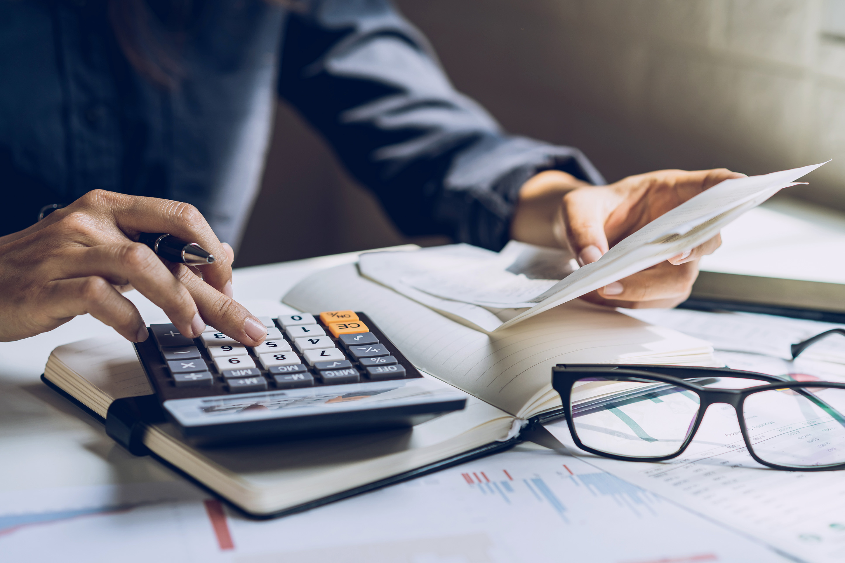 Person doing finances with a calculator