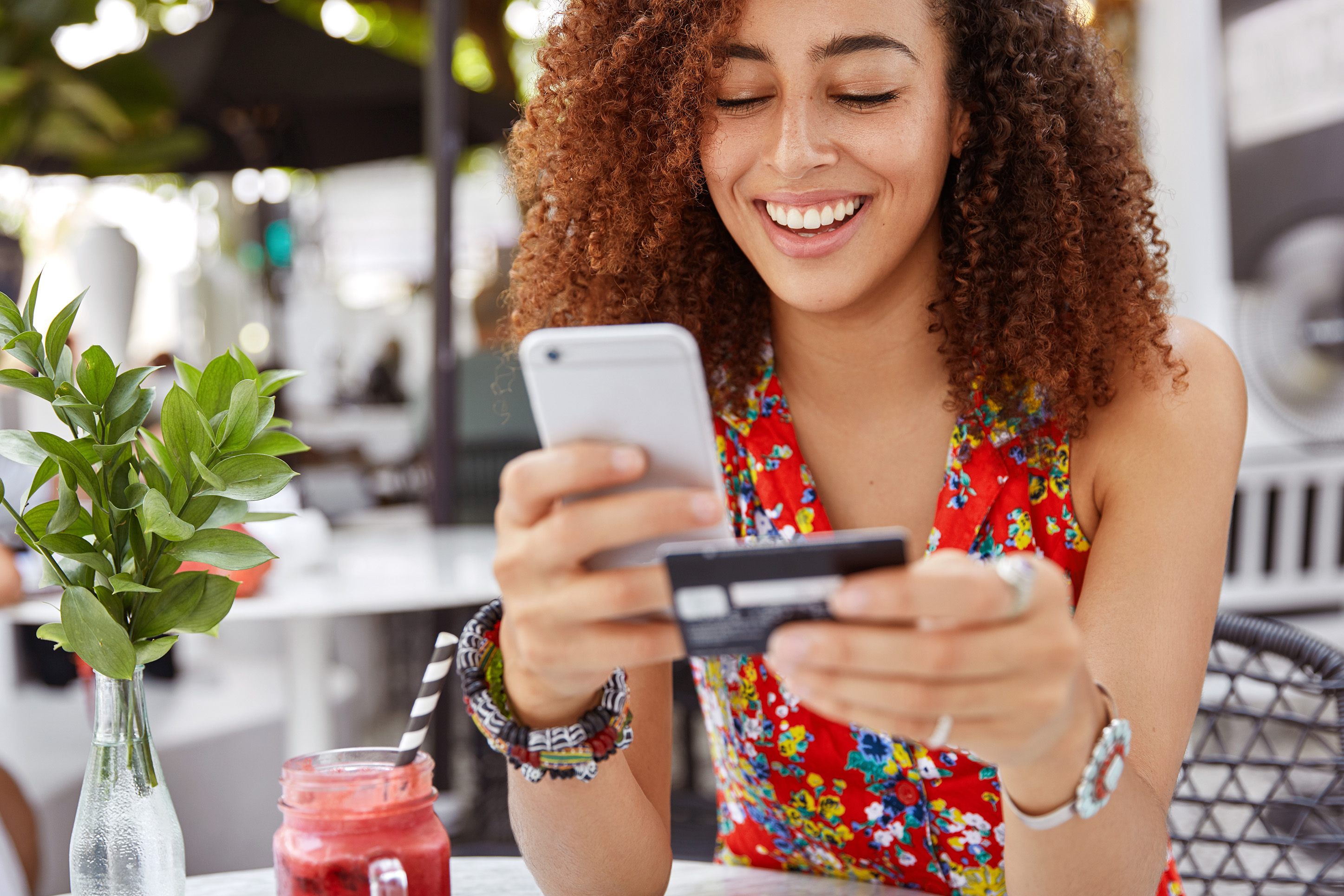 Woman with her phone and a credit card