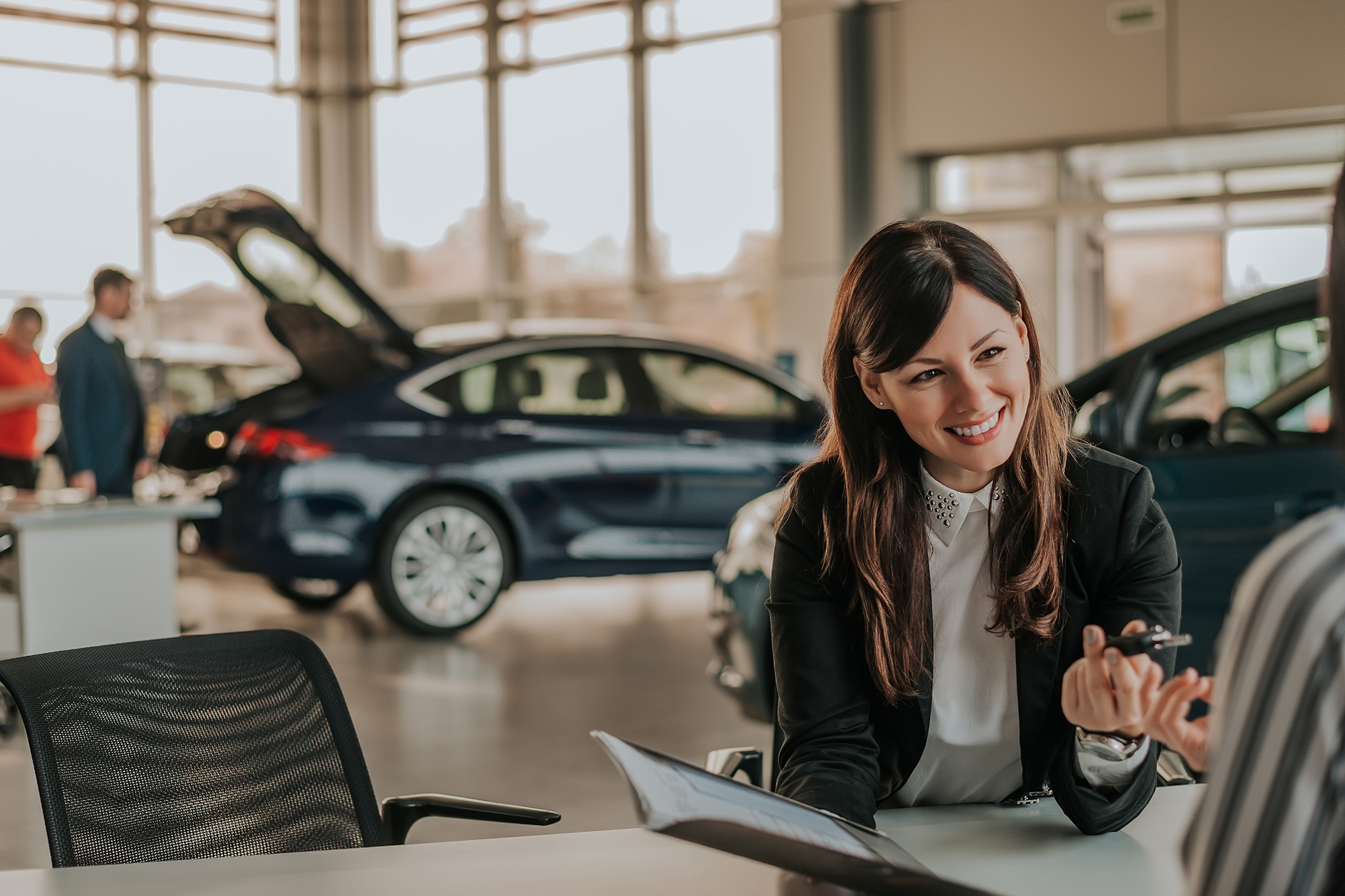Woman at a car dealership.