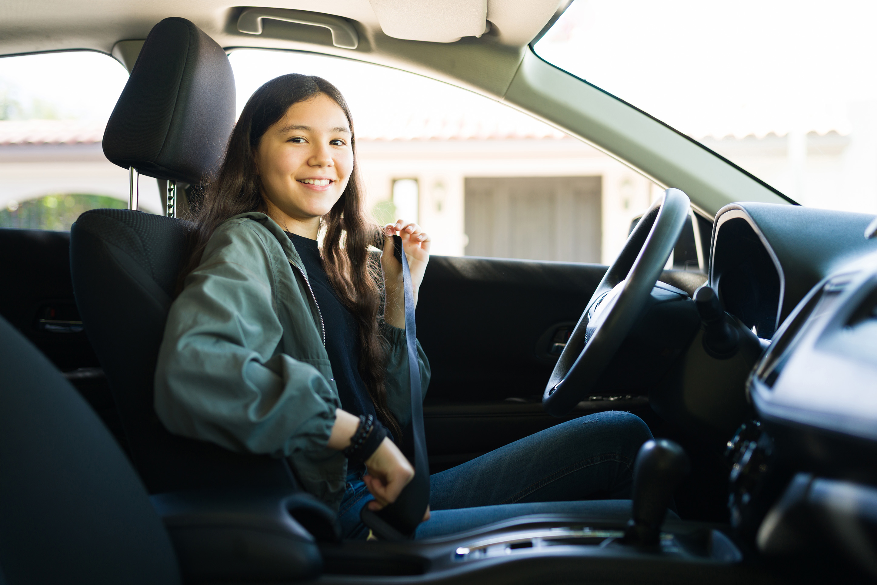 Young woman driving her first car.