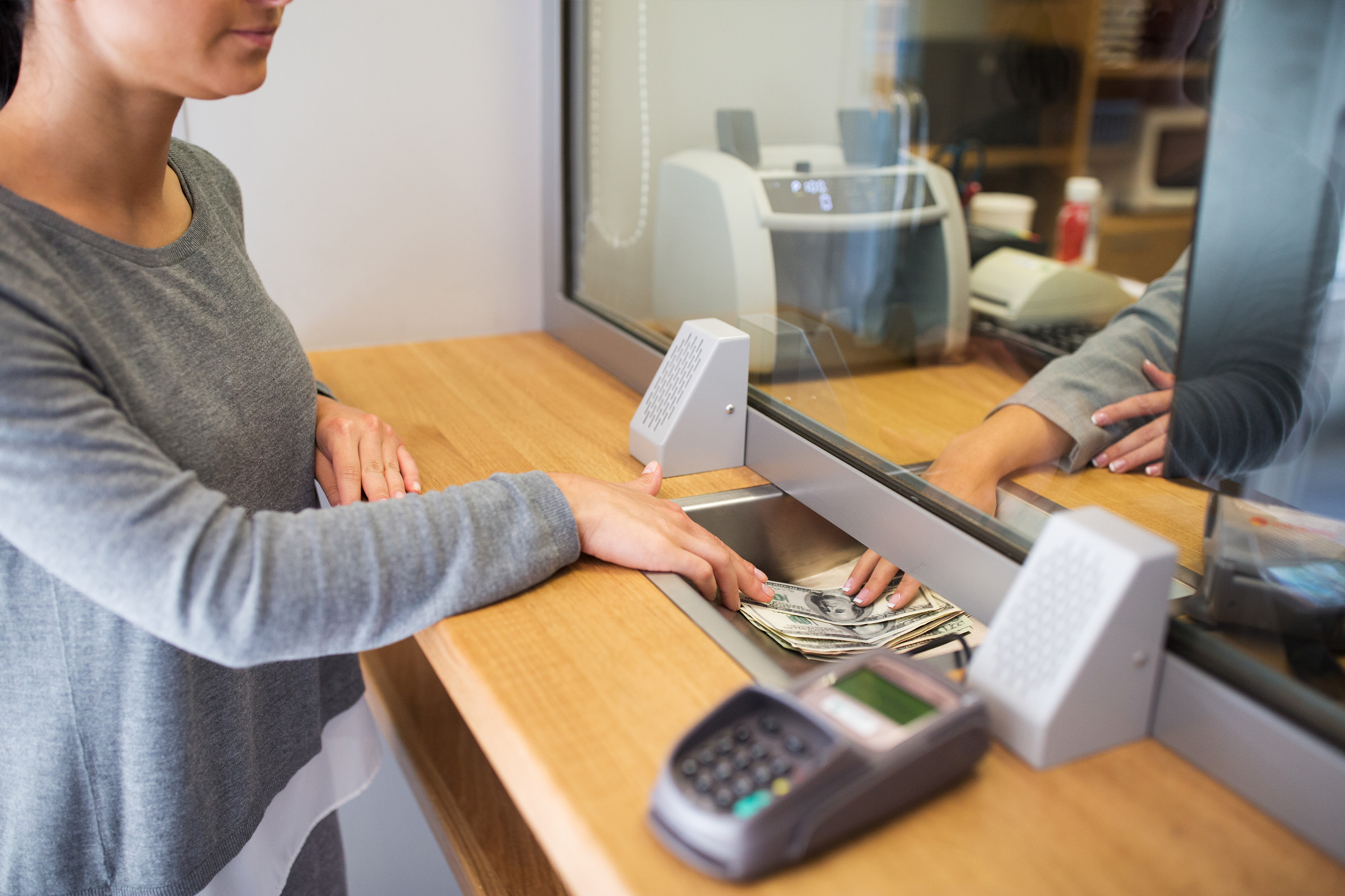 Woman putting money in savings.