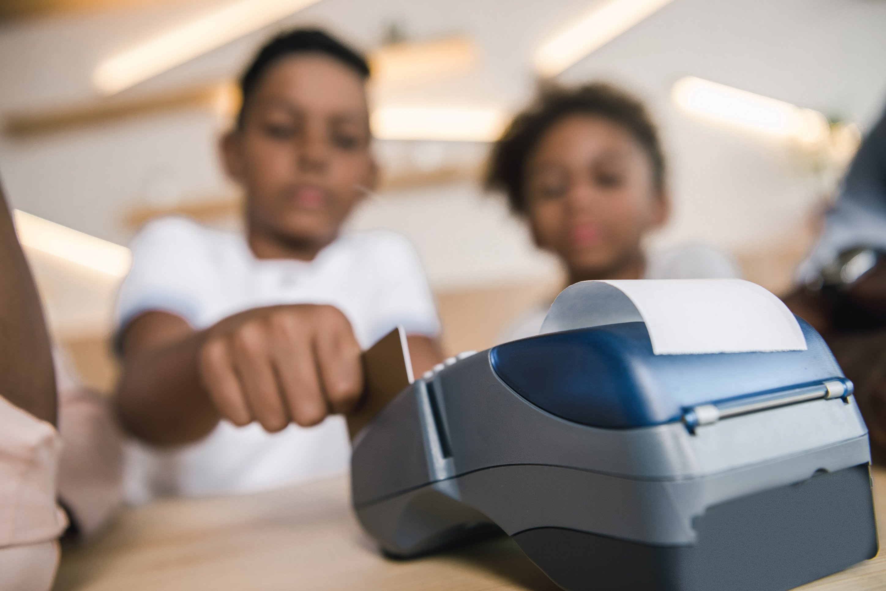 child using a credit card machine