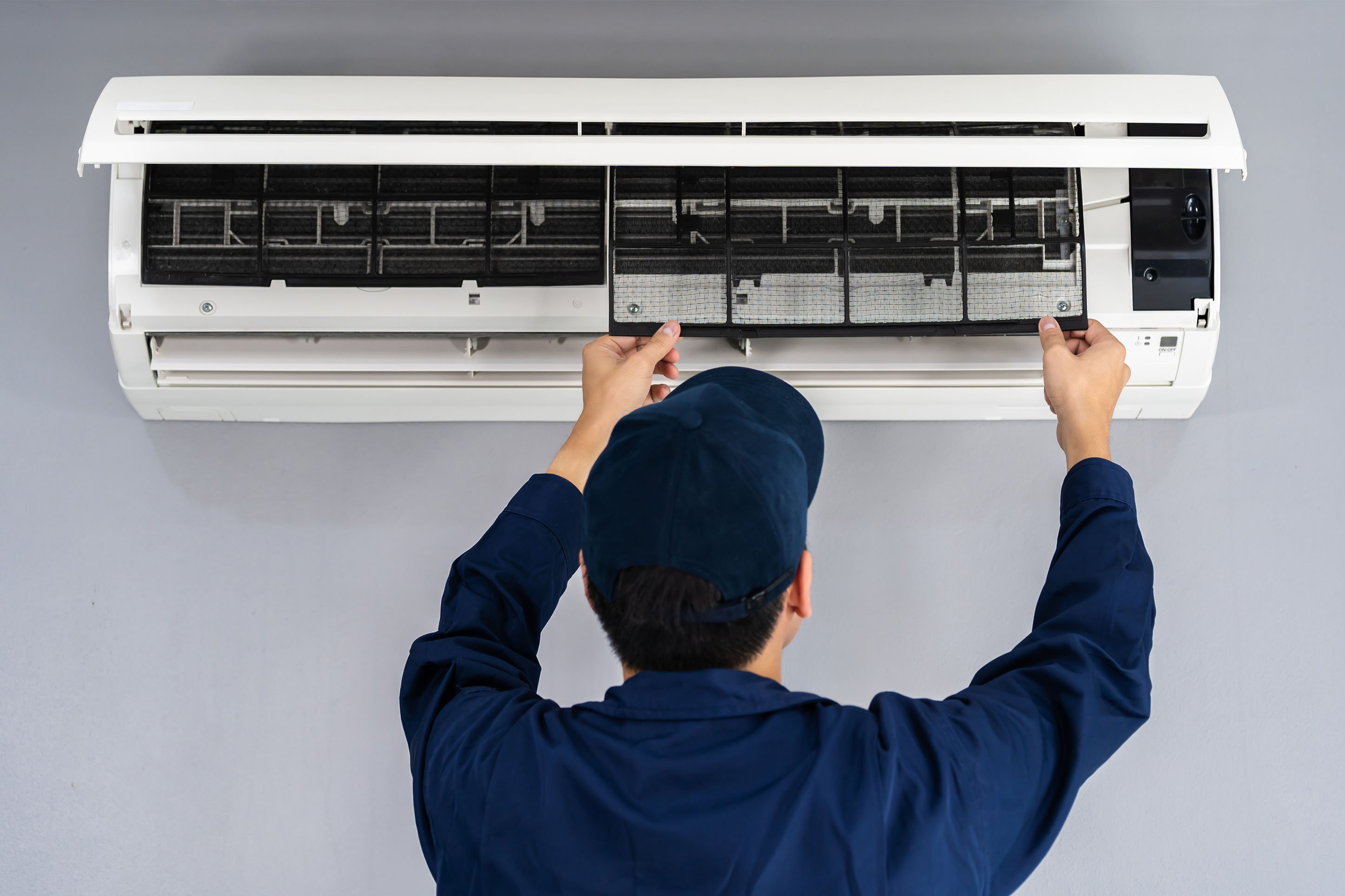 Man installing heating and cooling system. 