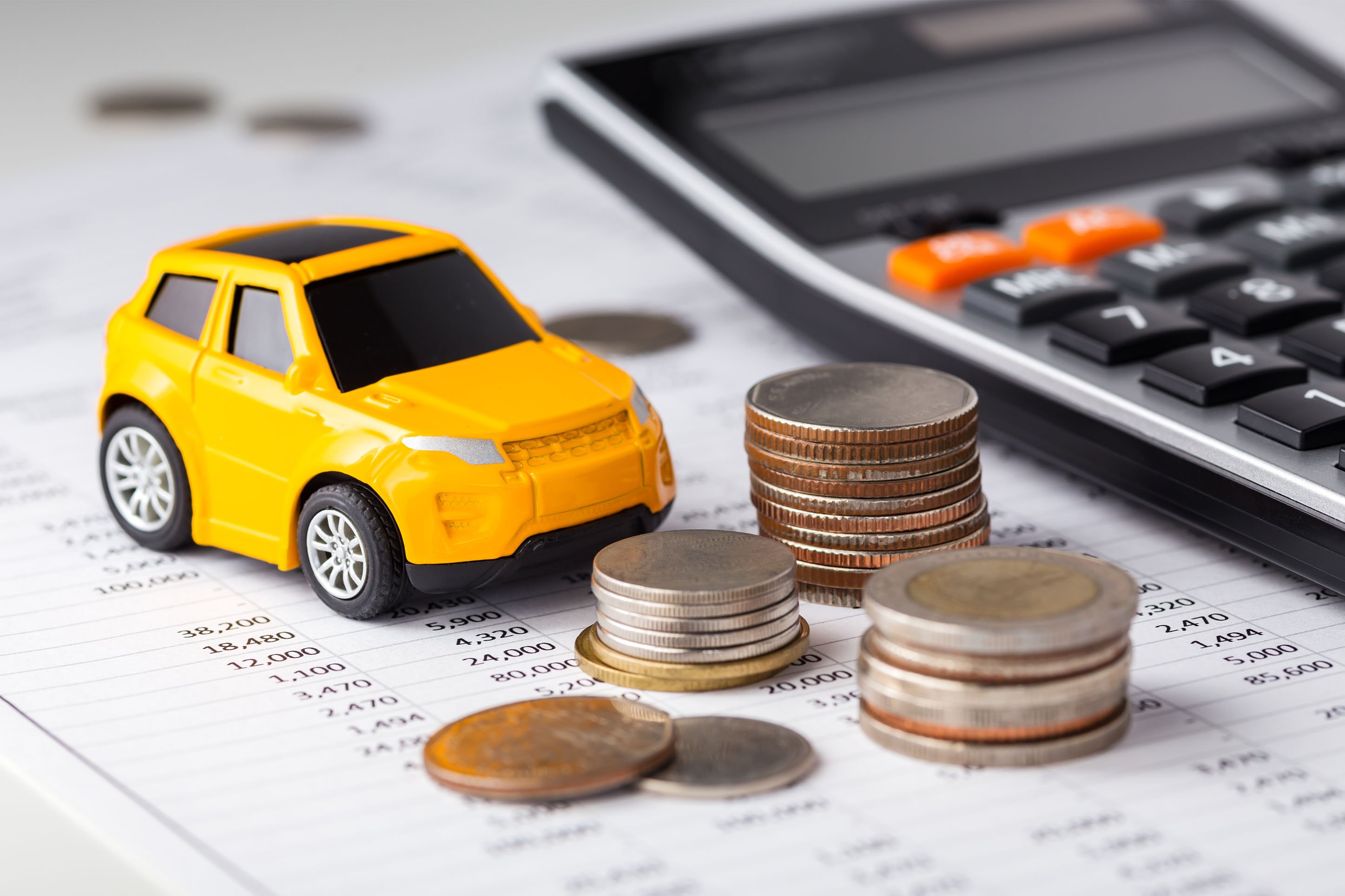 Image of toy auto and piles of coins.