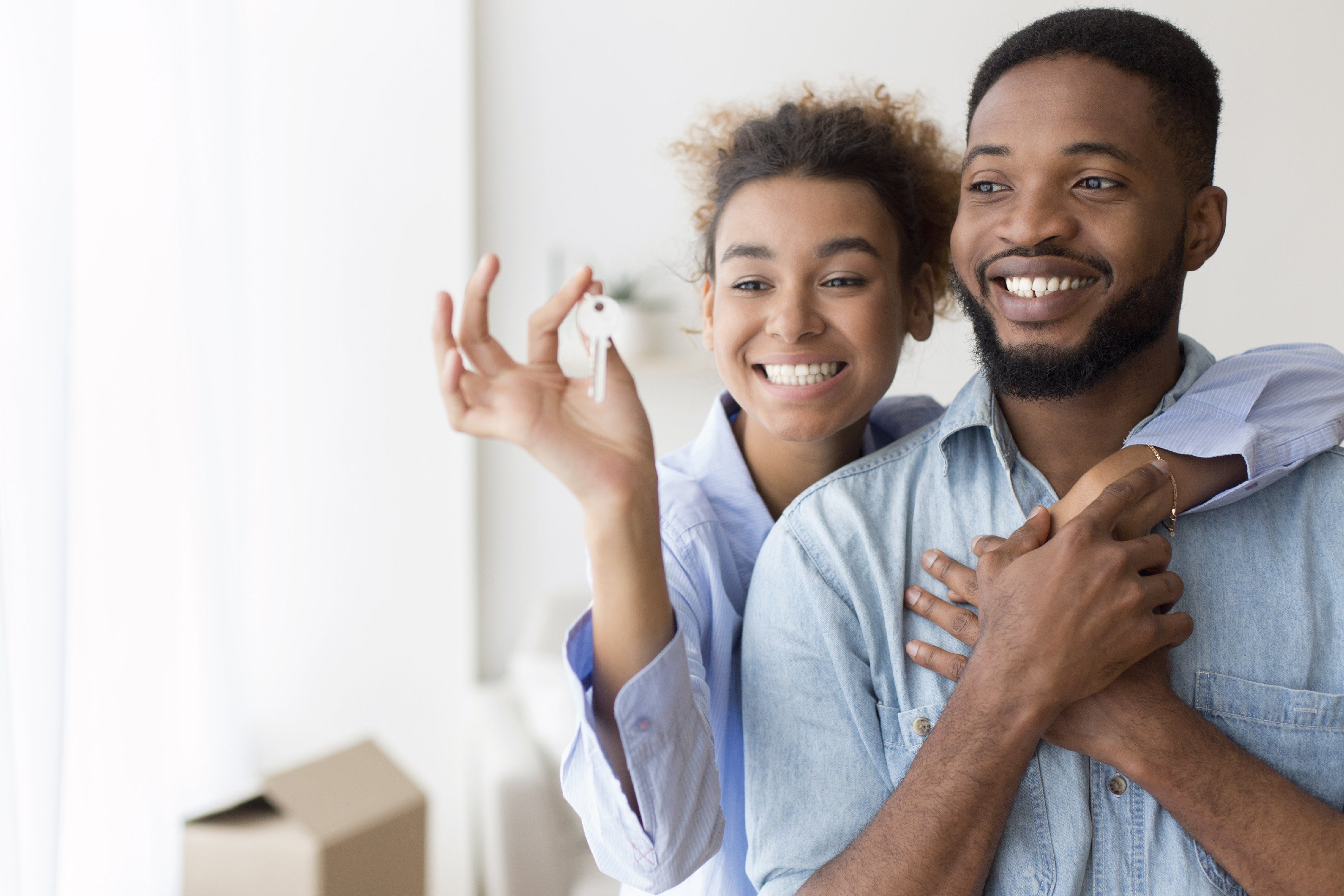 a couple holding keys to their new home
