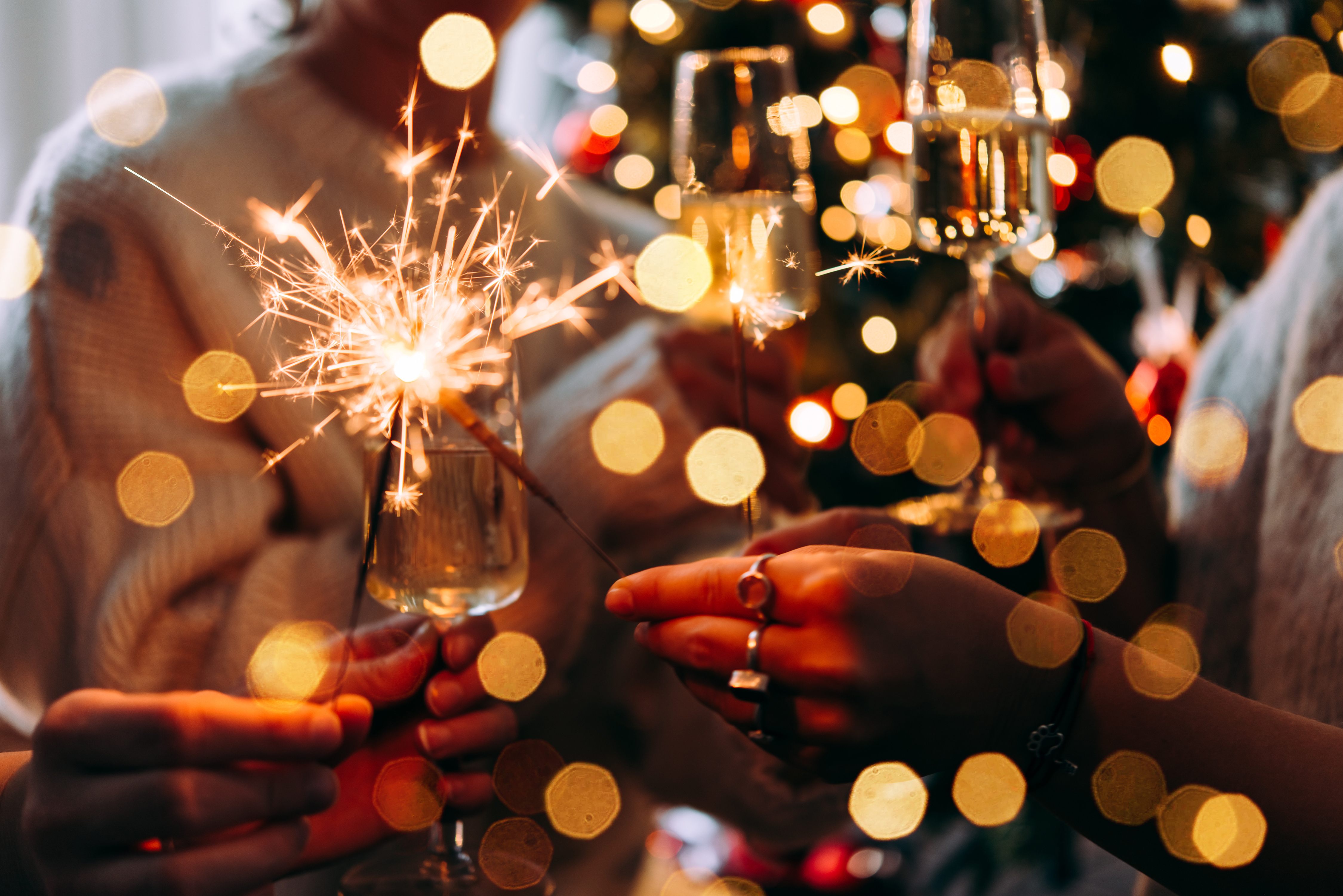 Hands holding sparklers to celebrate the new year