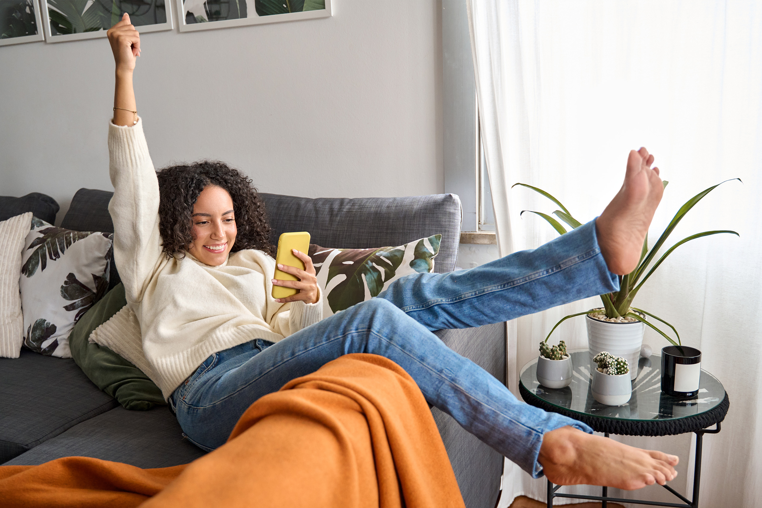 Woman on a chair excited about rewards programs 