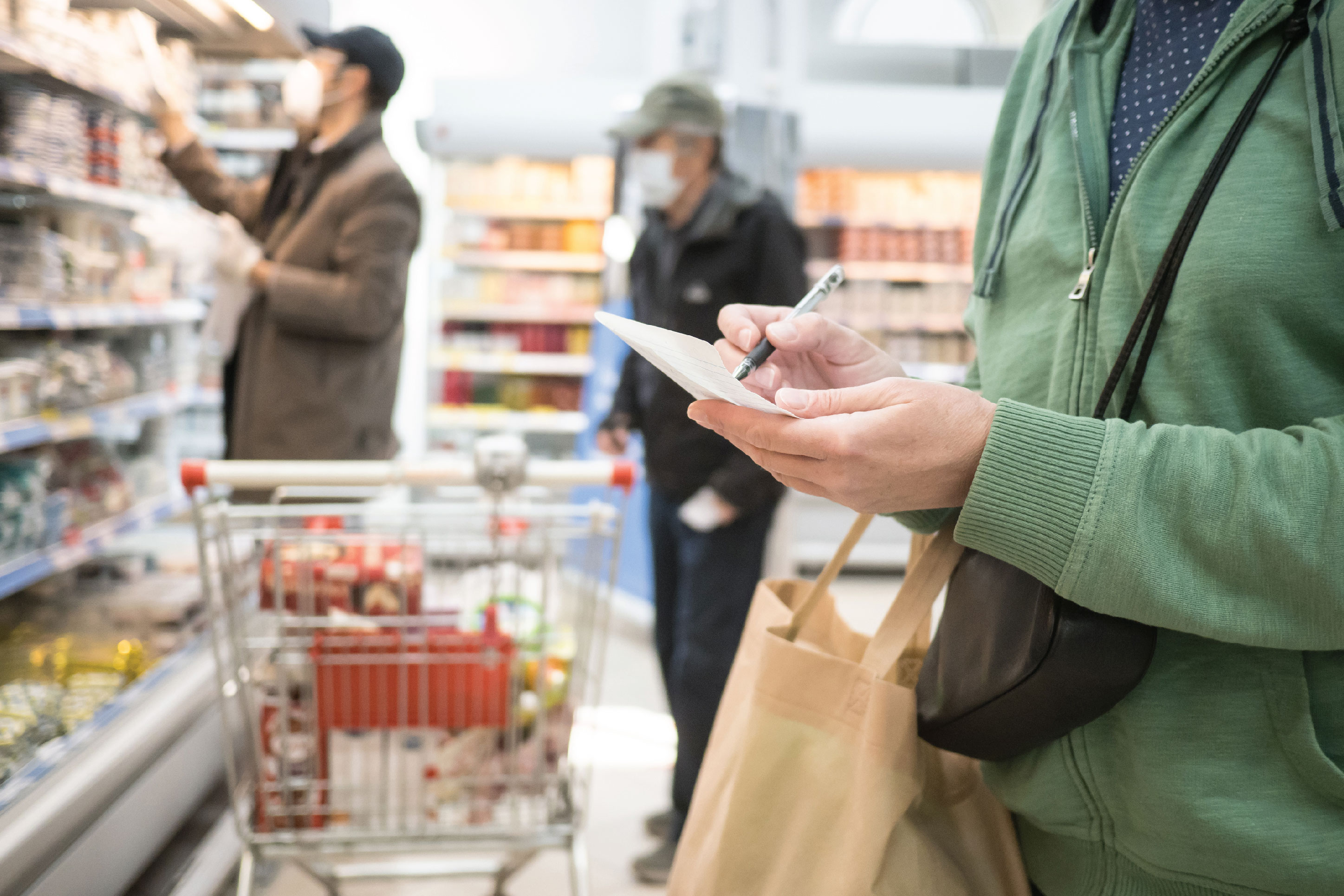 woman checking her grocery list at the store