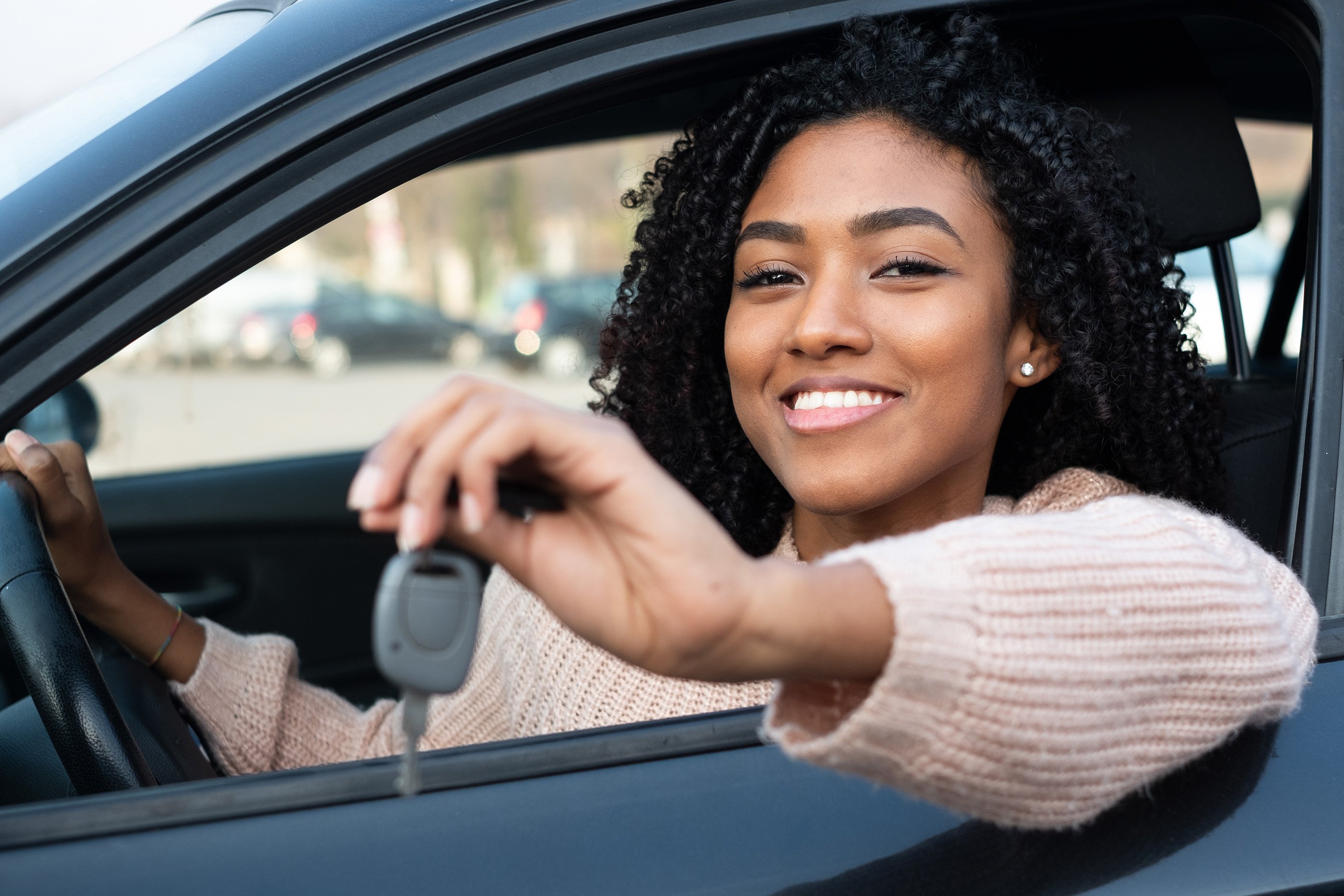 Woman with keys to new car.