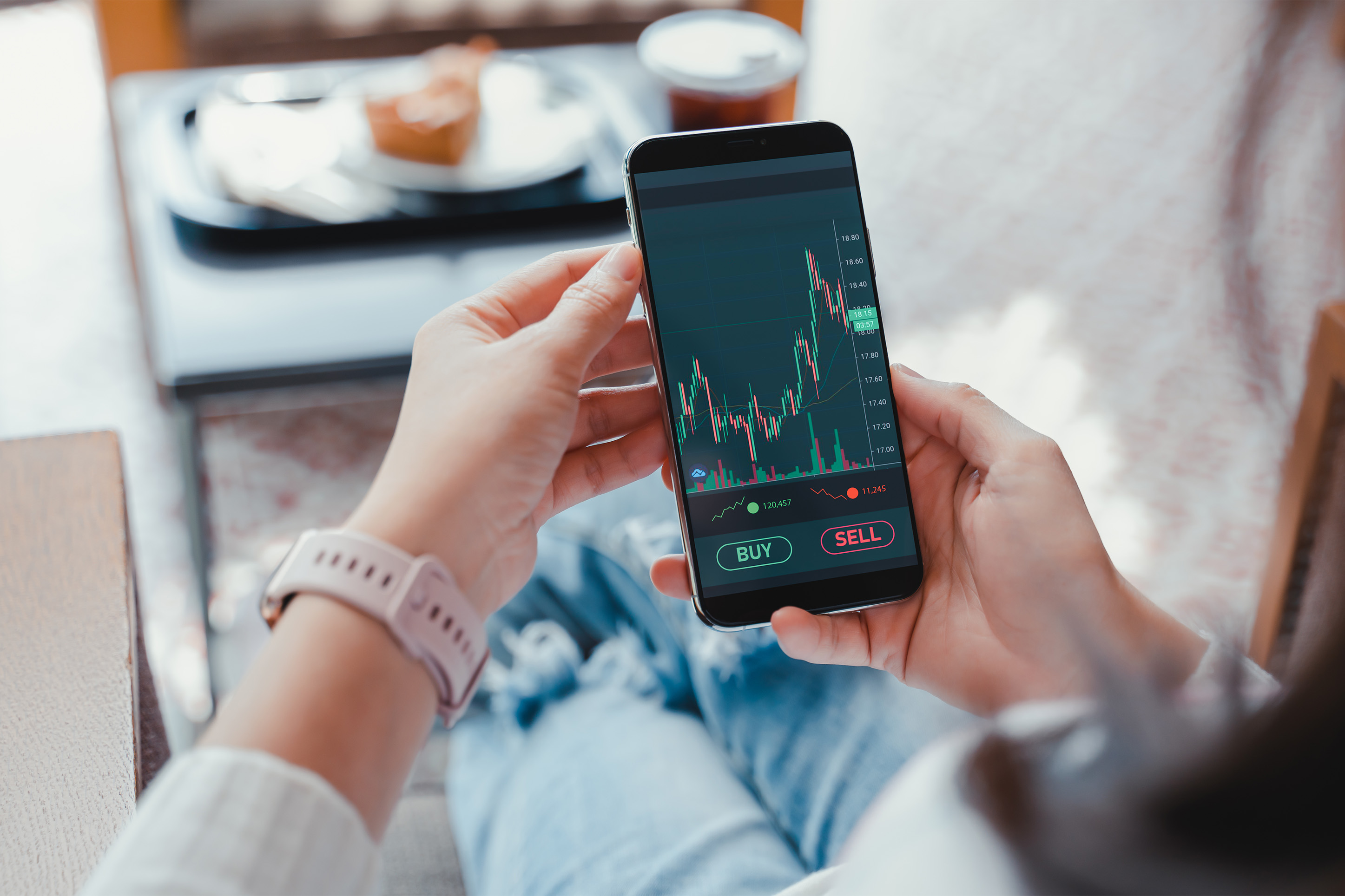 Person checking investments on a smart phone. 