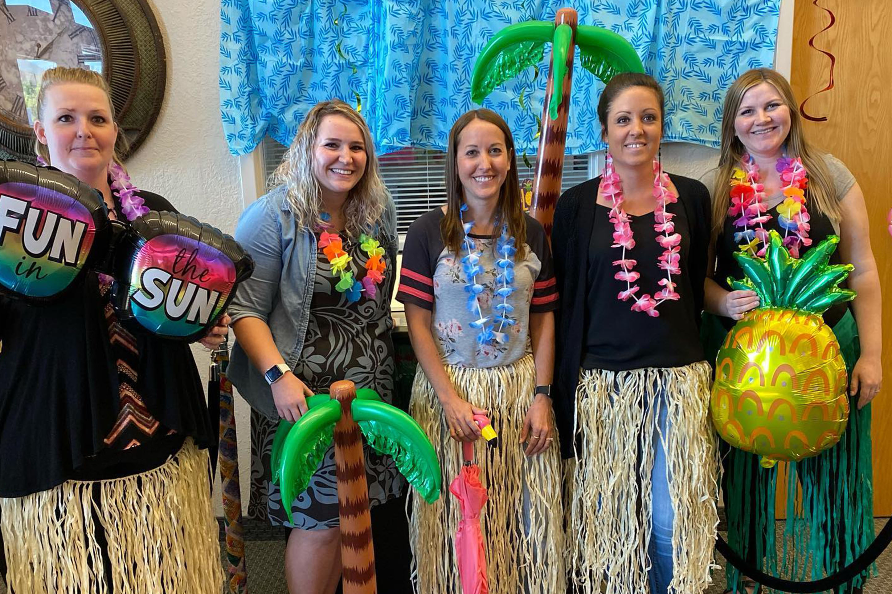 Photo Rocky Mountain Credit Union employees wearing Hawaiian outfits. 