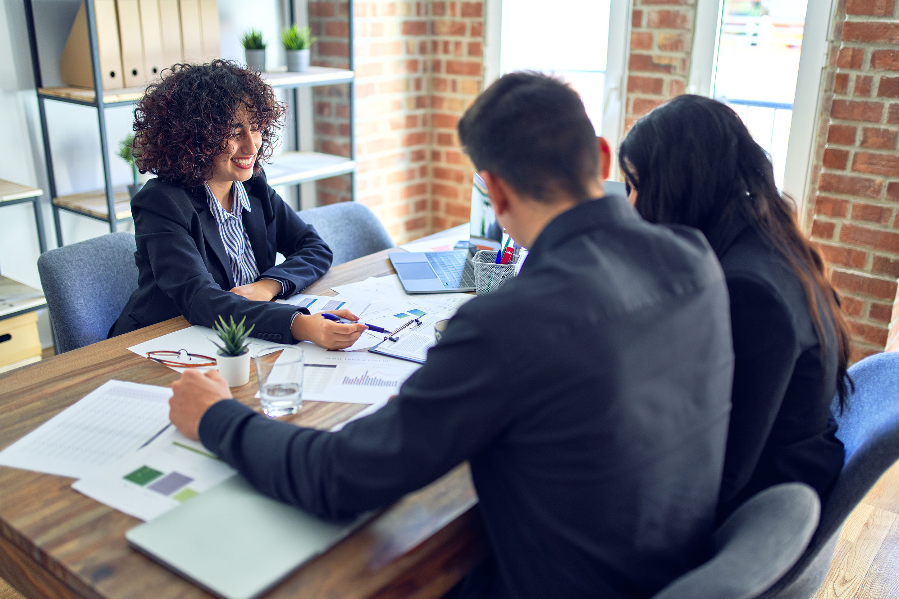 Couple at the table with a lender. 