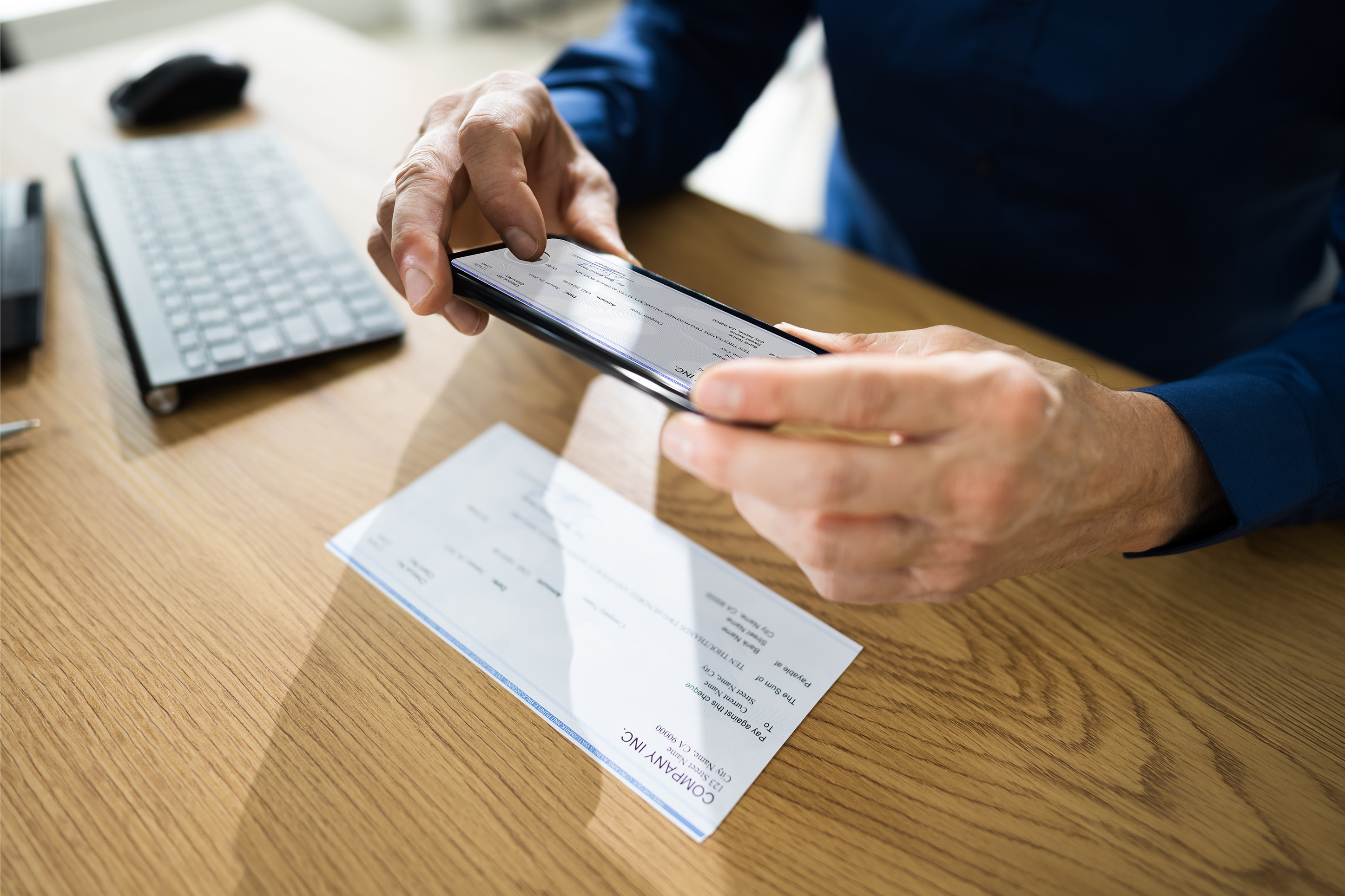 Person taking a photo of a check for online banking. 
