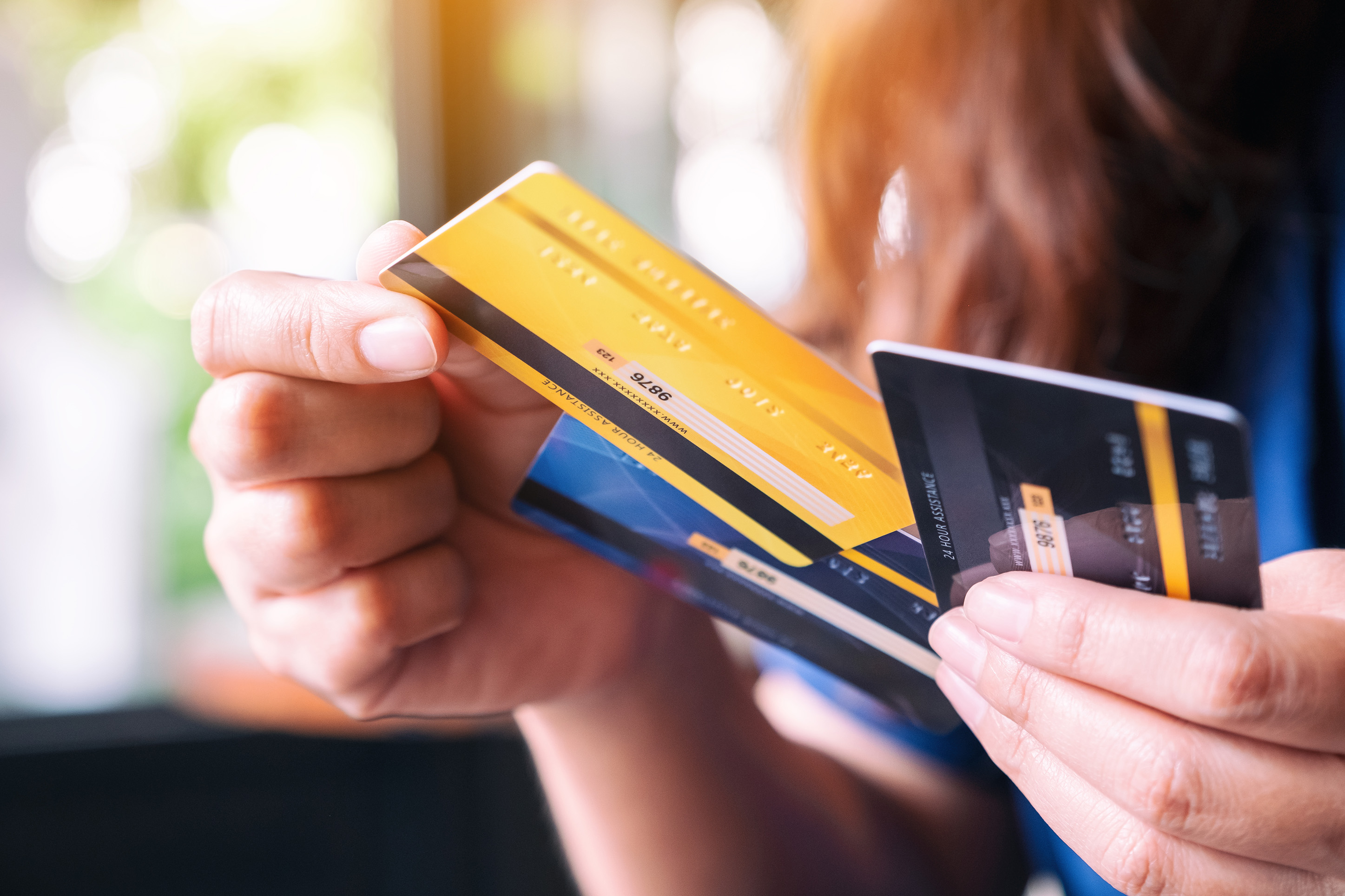 Someone pulling a credit card out of their wallet. 